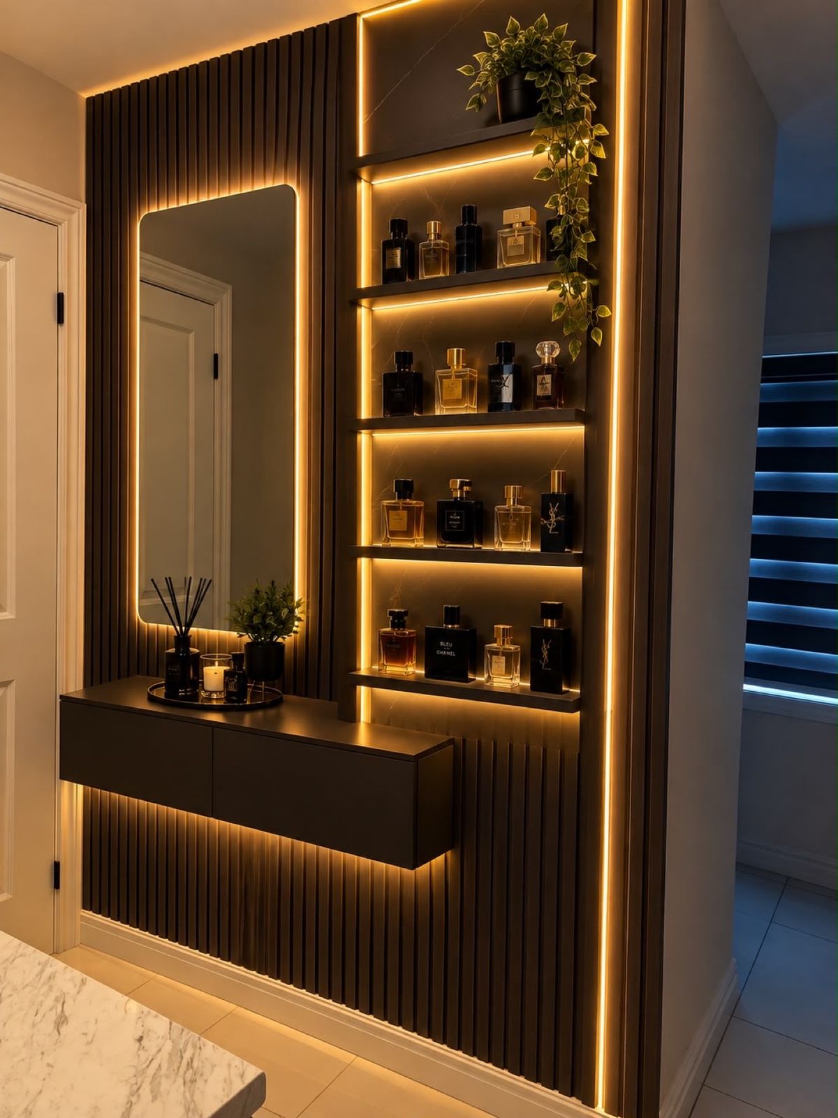 Slat wood accent wall with floating vanity, backlit mirror and LED display shelves by DK Construction Inc.
